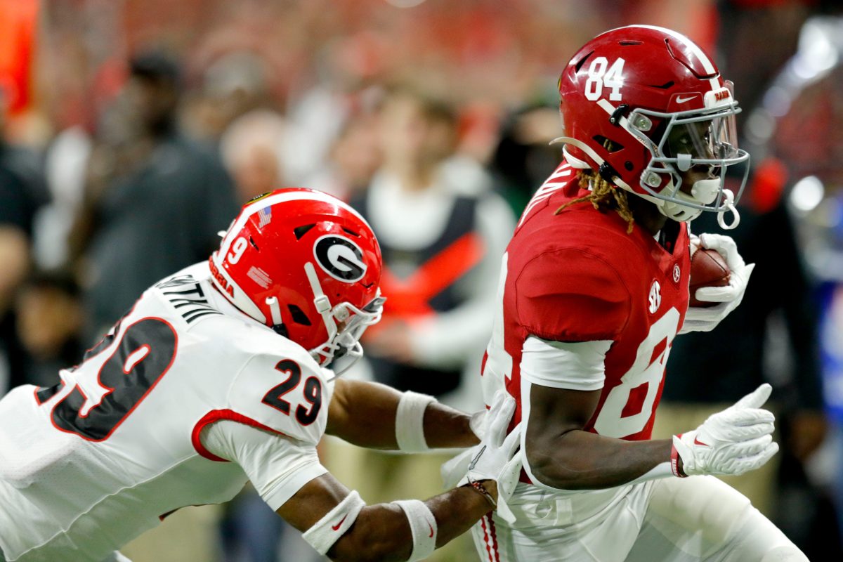 Georgia Bulldogs defensive back Christopher Smith (29) chases after Alabama Crimson Tide wide receiver Agiye Hall (84) on Monday, Jan. 10, 2022, during the College Football Playoff National Championship at Lucas Oil Stadium in Indianapolis.