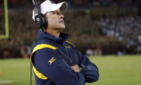 Sep 22, 2022; Blacksburg, Virginia, USA; West Virginia Mountaineers defensive coordinator Jordan Lesley watches from the bench during the second half against the Virginia Tech Hokies at Lane Stadium. Mandatory Credit: Reinhold Matay-Imagn Images