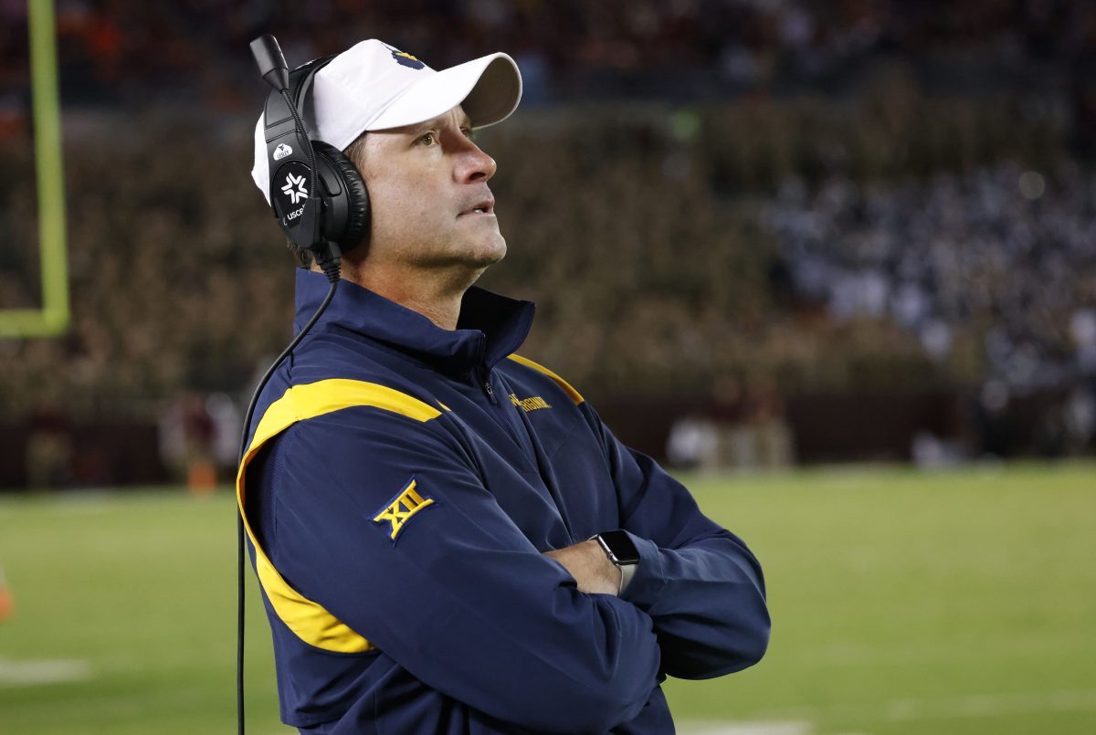 Sep 22, 2022; Blacksburg, Virginia, USA; West Virginia Mountaineers defensive coordinator Jordan Lesley watches from the bench during the second half against the Virginia Tech Hokies at Lane Stadium. Mandatory Credit: Reinhold Matay-Imagn Images