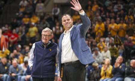 Dec 18, 2022; Morgantown, West Virginia, USA; West Virginia University President Gordon Gee welcomes new West Virginia Mountaineers Athletic Director Wren Baker during the first half against the Buffalo Bulls at WVU Coliseum. Mandatory Credit: Ben Queen-USA TODAY Sports