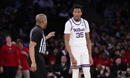 Referee pointing at Kansas State player Nae'Qwan Tomlin.