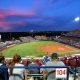 Fans watch the Women's College World Series softball game between Oklahoma and UCLA at the USA Softball Hall of Fame Stadium in Oklahoma City, Saturday, June 5, 2021, after storm caused a weather delay.