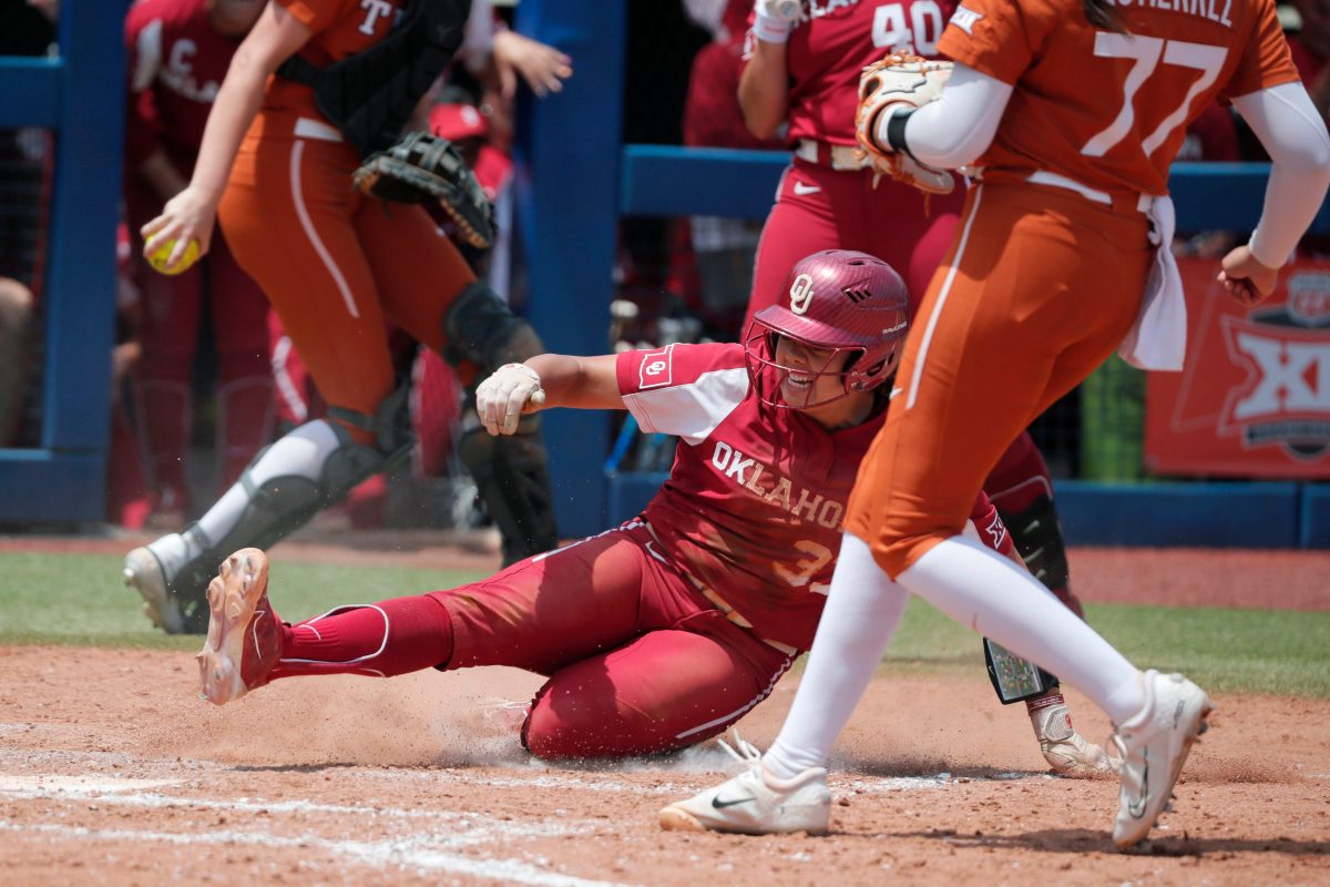 Oklahoma's Alyssa Brito (33) slides home to score a run in the fourth inning of the Big 12 softball tournament championship game between the University of Oklahoma Sooners (OU) and the Texas Longhorns at USA Softball Hall of Fame Stadium in Oklahoma City, Saturday, May 13, 2023. Oklahoma won 6-1.