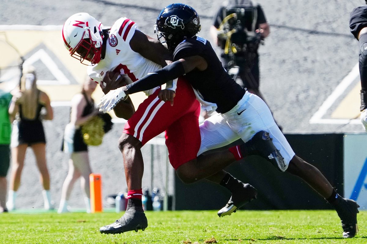 Sep 9, 2023; Boulder, Colorado, USA; Colorado Buffaloes cornerback Omarion Cooper (3) tackles Nebraska Cornhuskers quarterback Jeff Sims (7) in the second quarter at Folsom Field. Mandatory Credit: Ron Chenoy-USA TODAY Sports