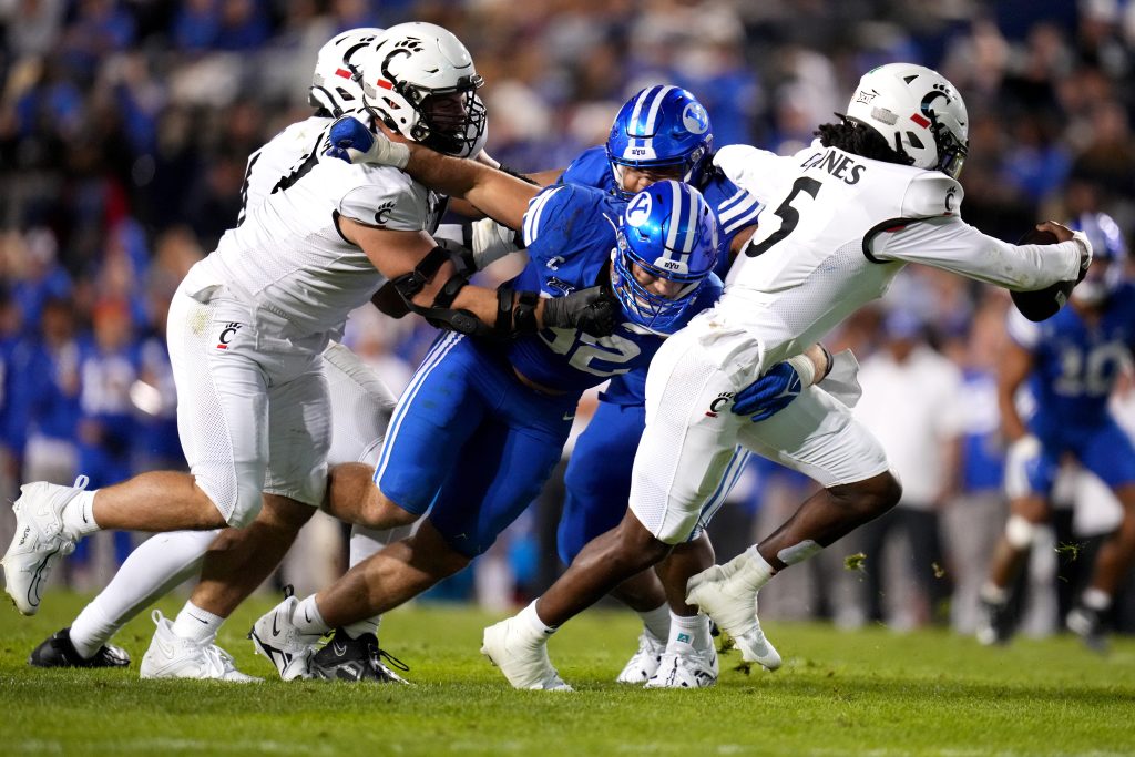 Brigham Young Cougars defensive end Tyler Batty (92) sacks Cincinnati Bearcats quarterback Emory Jones (5) in the fourth quarter during a college football game between the Brigham Young Cougars and the Cincinnati Bearcats, Saturday, Sept. 30, 2023, at LaVell Edwards Stadium in Provo, Utah.