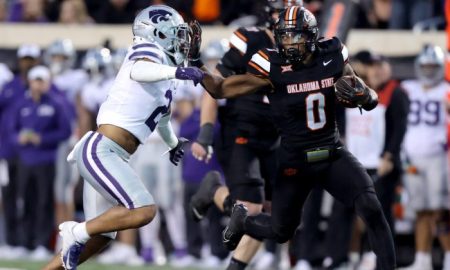 Oklahoma State's Ollie Gordon II (0) tries to get by Kansas State's Kobe Savage (2) in the first half of the college football game between the Oklahoma State University Cowboys and the Kansas State Wildcats at Boone Pickens Stadium in Stillwater. Okla., Friday, Oct. 6, 2023. OSU won 29-21.