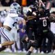 Oklahoma State's Ollie Gordon II (0) tries to get by Kansas State's Kobe Savage (2) in the first half of the college football game between the Oklahoma State University Cowboys and the Kansas State Wildcats at Boone Pickens Stadium in Stillwater. Okla., Friday, Oct. 6, 2023. OSU won 29-21.