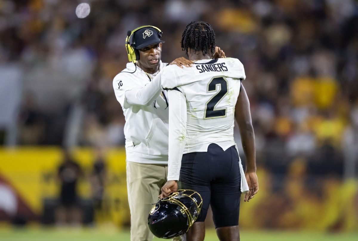 Oct 7, 2023; Tempe, Arizona, USA; Colorado Buffaloes head coach Deion Sanders with son and quarterback Shedeur Sanders (2) against the Arizona State Sun Devils at Mountain America Stadium. Mandatory Credit: Mark J. Rebilas-USA TODAY Sports