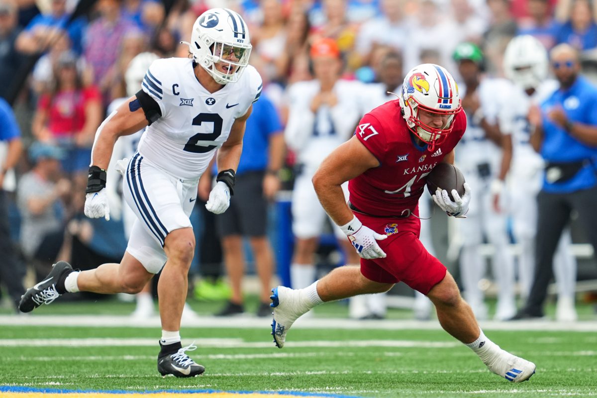 Sep 23, 2023; Lawrence, Kansas, USA; Kansas Jayhawks tight end Jared Casey (47) runs with the ball against Brigham Young Cougars linebacker Ben Bywater (2) during the first half at David Booth Kansas Memorial Stadium. Mandatory Credit: Jay Biggerstaff-USA TODAY Sports