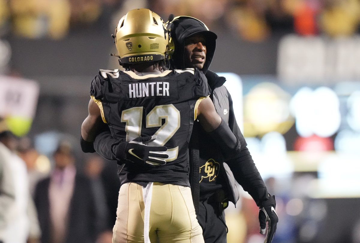 Oct 13, 2023; Boulder, Colorado, USA; Colorado Buffaloes wide receiver Travis Hunter (12) is congratulated for his touchdown by head coach Deion Sanders in the first quarter against the Stanford Cardinal at Folsom Field. Mandatory Credit: Ron Chenoy-USA TODAY Sports