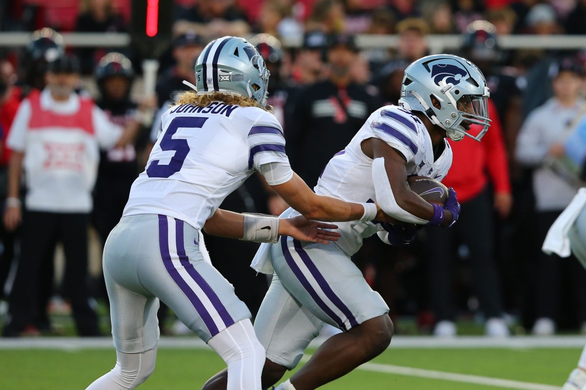 Oct 14, 2023; Lubbock, Texas, USA; Kansas State Wildcats quarterback Avery Johnson (5) hands the ball to running back DJ Giddens (31) in the first half during the game against the Texas Tech Red Raiders at Jones AT&T Stadium and Cody Campbell Field. Mandatory Credit: Michael C. Johnson-USA TODAY Sports