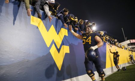 Nov 4, 2023; Morgantown, West Virginia, USA; West Virginia Mountaineers offensive lineman Zach Frazier (54) celebrates with fans after defeating the Brigham Young Cougars at Mountaineer Field at Milan Puskar Stadium. Mandatory Credit: Ben Queen-USA TODAY Sports