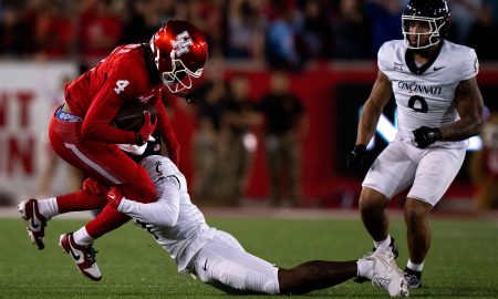 Cincinnati Bearcats cornerback Jordan Young (1) tackles Houston Cougars wide receiver Samuel Brown (4) in the fourth quarter of the NCAA football game between the Cincinnati Bearcats and the Houston Cougars TDECU Stadium in Houston, Texas, on Saturday, Nov. 11, 2023.