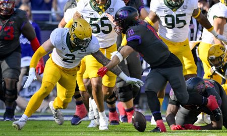 Nov 18, 2023; Fort Worth, Texas, USA; Baylor Bears linebacker Matt Jones (2) and TCU Horned Frogs quarterback Josh Hoover (10) battle for control of a fumble during the first half at Amon G. Carter Stadium. Mandatory Credit: Jerome Miron-USA TODAY Sports