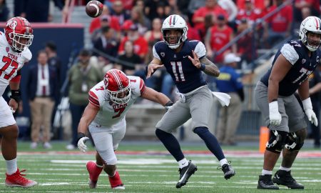 Nov 18, 2023; Tucson, Arizona, USA; Arizona Wildcats quarterback Noah Fifita (11) throws a pass against Utah Utes defensive end Van Fillinger (7) during the second half at Arizona Stadium. Mandatory Credit: Zachary BonDurant-USA TODAY Sports