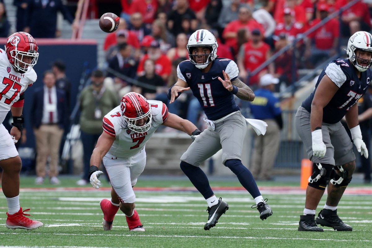 Nov 18, 2023; Tucson, Arizona, USA; Arizona Wildcats quarterback Noah Fifita (11) throws a pass against Utah Utes defensive end Van Fillinger (7) during the second half at Arizona Stadium. Mandatory Credit: Zachary BonDurant-USA TODAY Sports