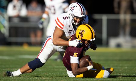 Nov 25, 2023; Tempe, Arizona, USA; Arizona Wildcats linebacker Jacob Manu (top) sacks Arizona State Sun Devils quarterback Jaden Rashada in the second half of the Territorial Cup at Mountain America Stadium. Mandatory Credit: Mark J. Rebilas-USA TODAY Sports