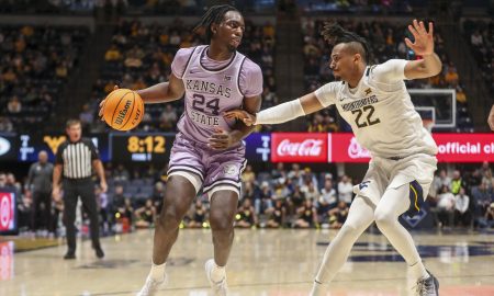 Jan 9, 2024; Morgantown, West Virginia, USA; Kansas State Wildcats forward Arthur Kaluma (24) dribbles against West Virginia Mountaineers forward Josiah Harris (22) during the first half at WVU Coliseum. Mandatory Credit: Ben Queen-USA TODAY Sports