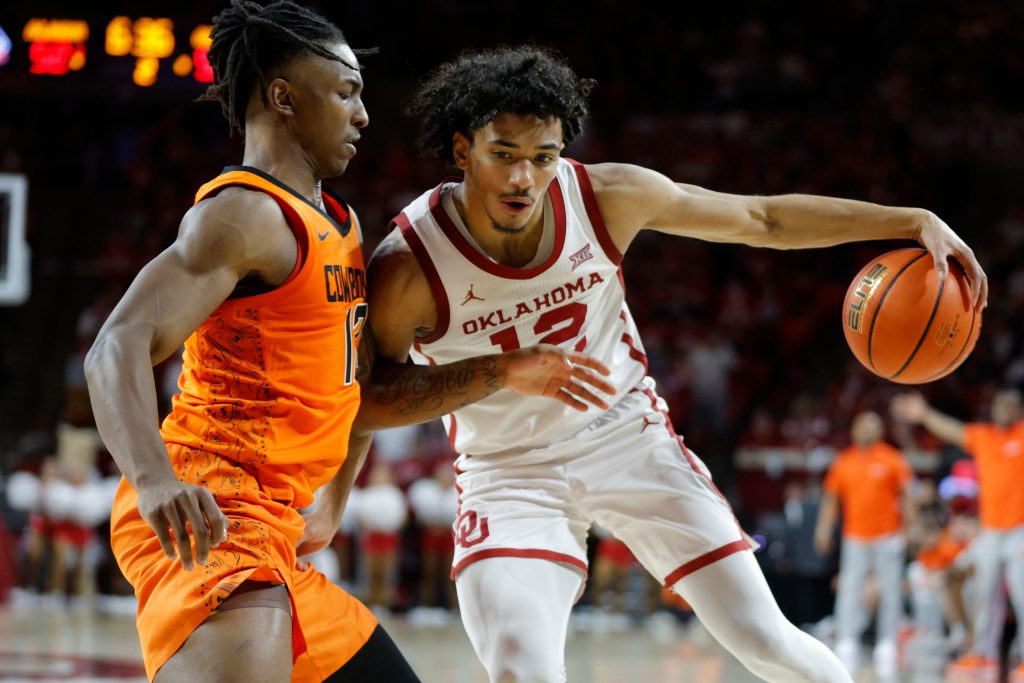 Oklahoma Sooners guard Milos Uzan (12) tries to get past Oklahoma State Cowboys guard Javon Small (12) during a Bedlam college basketball game between the University of Oklahoma Sooners (OU) and the Oklahoma State Cowboys (OSU) at Lloyd Noble Center in Norman, Okla., Saturday, Feb. 10, 2024. Oklahoma won 66-62.