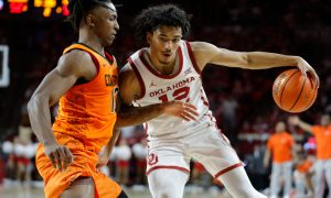 Oklahoma Sooners guard Milos Uzan (12) tries to get past Oklahoma State Cowboys guard Javon Small (12) during a Bedlam college basketball game between the University of Oklahoma Sooners (OU) and the Oklahoma State Cowboys (OSU) at Lloyd Noble Center in Norman, Okla., Saturday, Feb. 10, 2024. Oklahoma won 66-62.