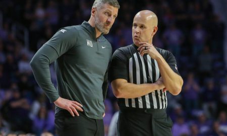 Feb 26, 2024; Manhattan, Kansas, USA; West Virginia Mountaineers interim head coach Josh Eilert listens to an official during overtime against the Kansas State Wildcats at Bramlage Coliseum. Mandatory Credit: Scott Sewell-USA TODAY Sports