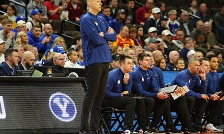 Mar 21, 2024; Omaha, NE, USA; Brigham Young Cougars head coach Mark Pope keeps an eye on the action against the Duquesne Dukes in the first round of the 2024 NCAA Tournament at CHI Health Center Omaha. Mandatory Credit: Dylan Widger-USA TODAY Sports