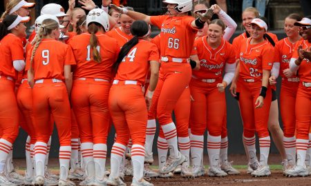 Oklahoma State's Caroline Wang (66) celebrates as she comes home after hitting a three-run home run in the first inning of a college softball game between the Oklahoma State University Cowgirls and the Texas Longhorns in Stillwater, Okla., Saturday, March 30, 2024. Oklahoma State won 3-0.