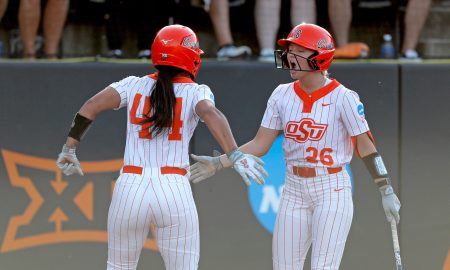 Oklahoma State's Tallen Edwards (44) and Rosie Davis (26) celebrate during the NCAA softball tournament Stillwater Super Regional game between the Oklahoma State Cowgirls and the Arizona Wildcats in Stillwater, Okla., Friday, May, 24, 2024.