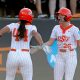 Oklahoma State's Tallen Edwards (44) and Rosie Davis (26) celebrate during the NCAA softball tournament Stillwater Super Regional game between the Oklahoma State Cowgirls and the Arizona Wildcats in Stillwater, Okla., Friday, May, 24, 2024.