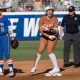 Jun 1, 2024; Oklahoma City, OK, USA; Texas Longhorns utility Katie Stewart (20) yells after hitting a double as Florida Gators infielder Mia Williams (11) looks on in the first inning during a Women's College World Series softball winners bracket game at Devon Park. Mandatory Credit: Brett Rojo-USA TODAY Sports