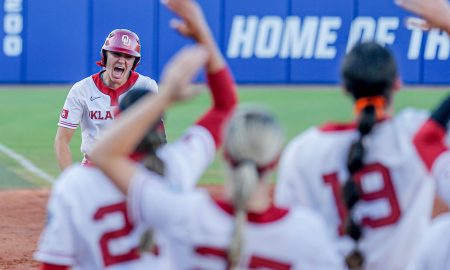 Oklahoma catcher Kinzie Hansen (9) hits a home run in the third inning of the first game of the Women’s College World Series softball championship series between the Oklahoma Sooners and the Texas Longhorns at Devon Park in Oklahoma City on Wednesday, June 5, 2024.