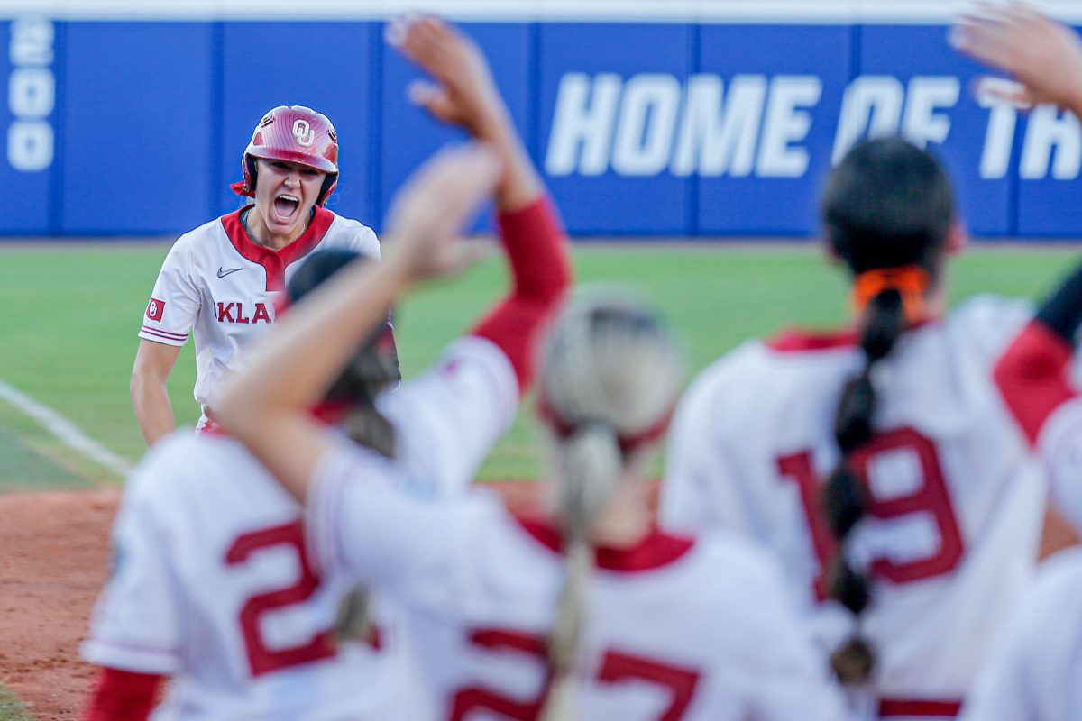 Oklahoma catcher Kinzie Hansen (9) hits a home run in the third inning of the first game of the Women’s College World Series softball championship series between the Oklahoma Sooners and the Texas Longhorns at Devon Park in Oklahoma City on Wednesday, June 5, 2024.