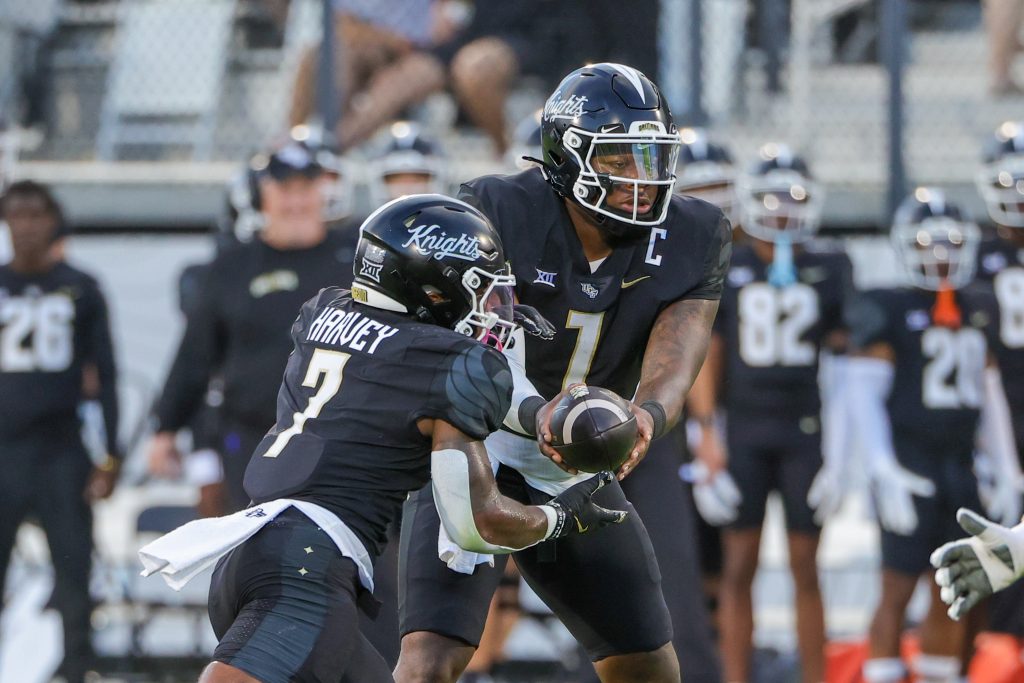 Aug 29, 2024; Orlando, Florida, USA; UCF Knights quarterback KJ Jefferson (1) hands off to running back RJ Harvey (7) during the first quarter against the New Hampshire Wildcats at FBC Mortgage Stadium. Mandatory Credit: Mike Watters-USA TODAY Sports