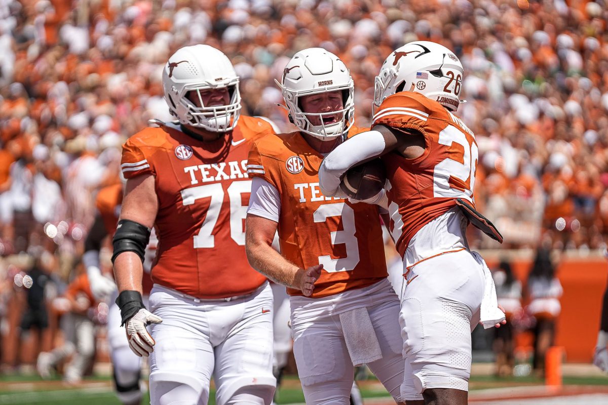 Texas Longhorns quarterback Quinn Ewers (3) and offensive lineman Hayden Conner (76) celebrate a touchdown by running back Quintrevion Wisner (26) against Colorado State at Darrell K Royal-Texas Memorial Stadium in Austin Saturday, Aug. 31, 2024.