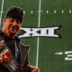 WWE Legend The Undertaker holding a Big 12 Championship Title Belt.